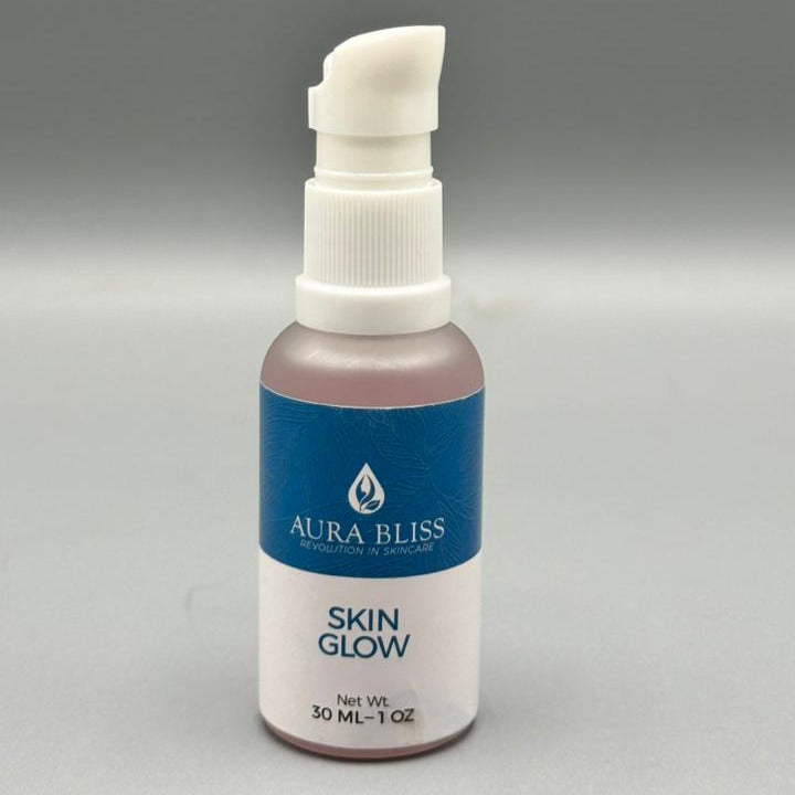 Bottle of Aura Bliss Skin Glow on a gray background